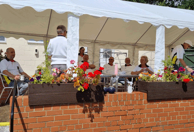 Players sitting under the marquee